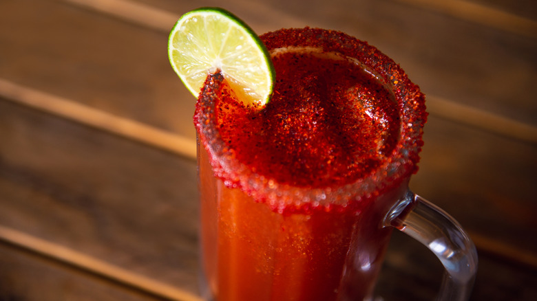 Glass of michelada with a lemon wheel