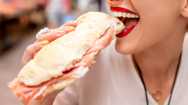 Woman eating sandwich