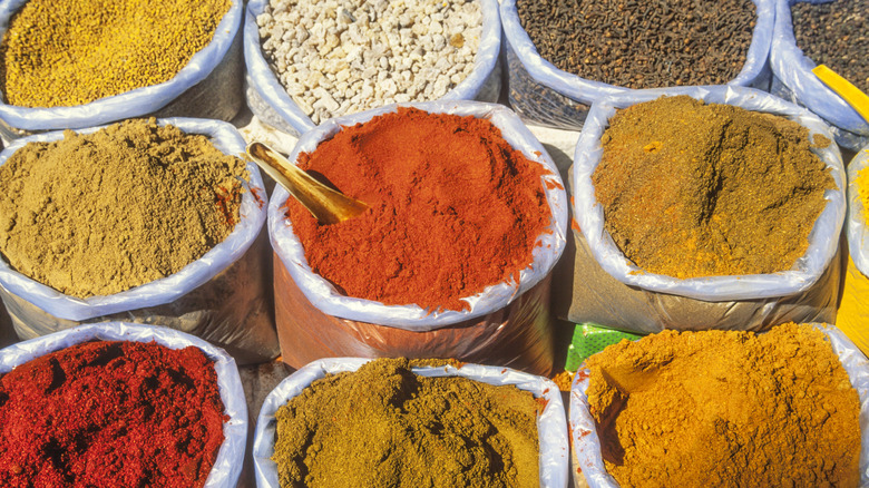 large bags of spices at a market