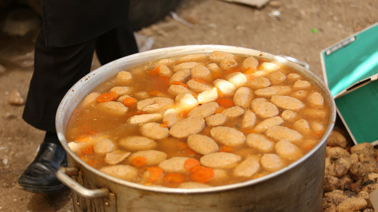 Gefilte fish quenelles in large pot