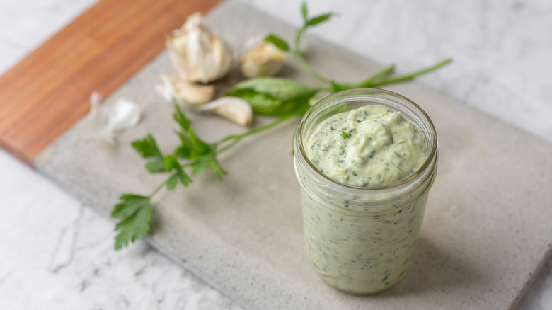 Jar of green goddess with herbs and garlic