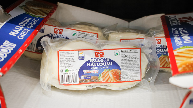 Packages of halloumi are on display on a supermarket shelf.