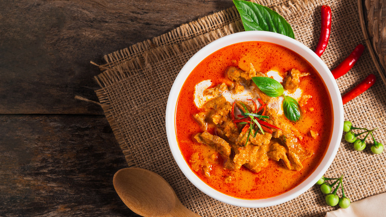 Curry in a white bowl on burlap