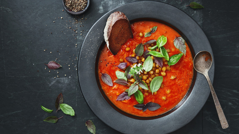 Harissa soup in gray bowl on gray background
