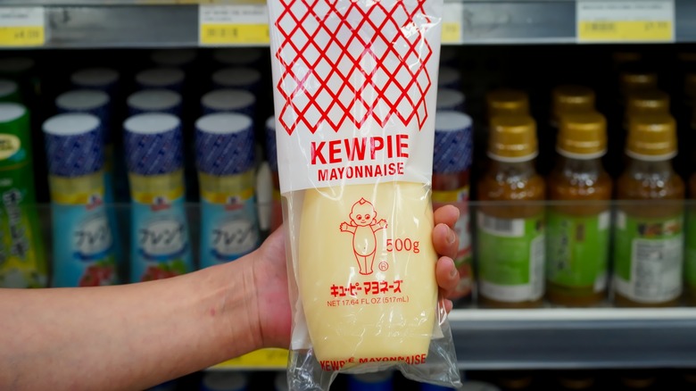 Hand holding Kewpie bottle 