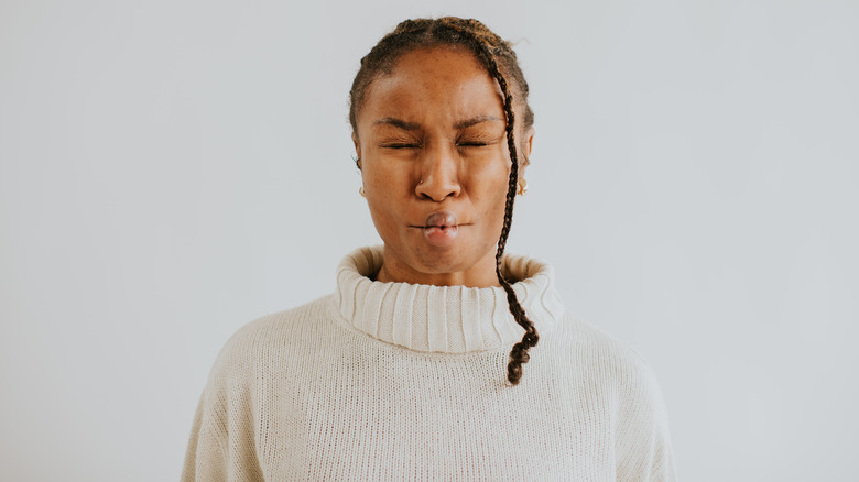 young woman making disgusted face