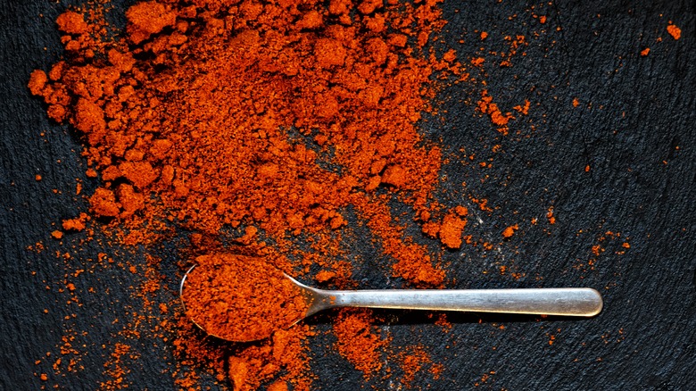 paprika powder on black background