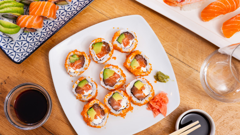 Plate of masago-covered sushi rolls