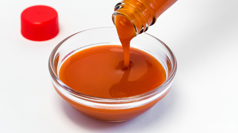 Buffalo sauce in clear glass bowl