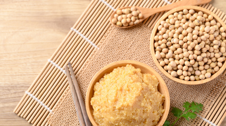 white miso paste next to soybeans
