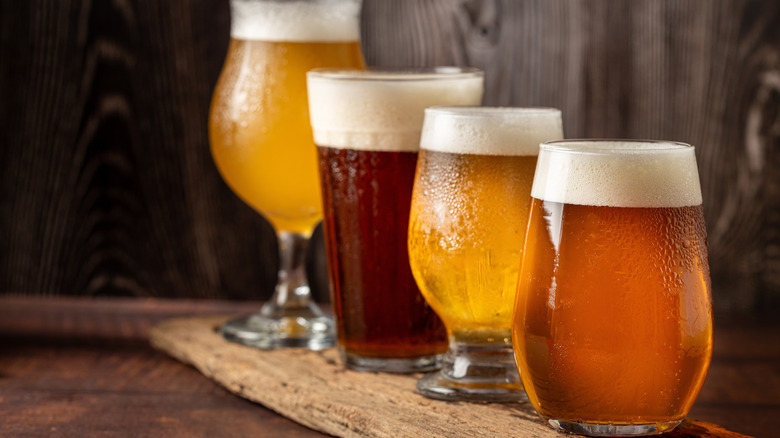 Four different beer glasses in a line