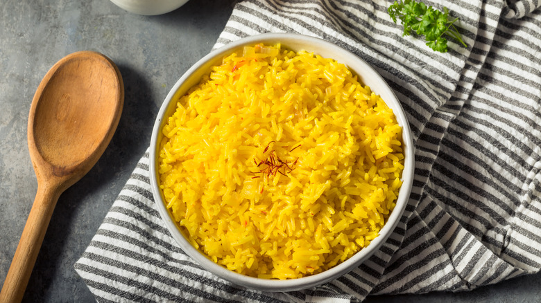 Bowl of saffron rice on table