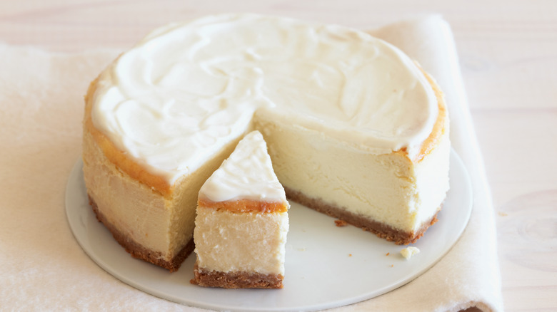 plain cheesecake partially sliced