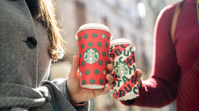 Starbucks red cup on a table with candy canes