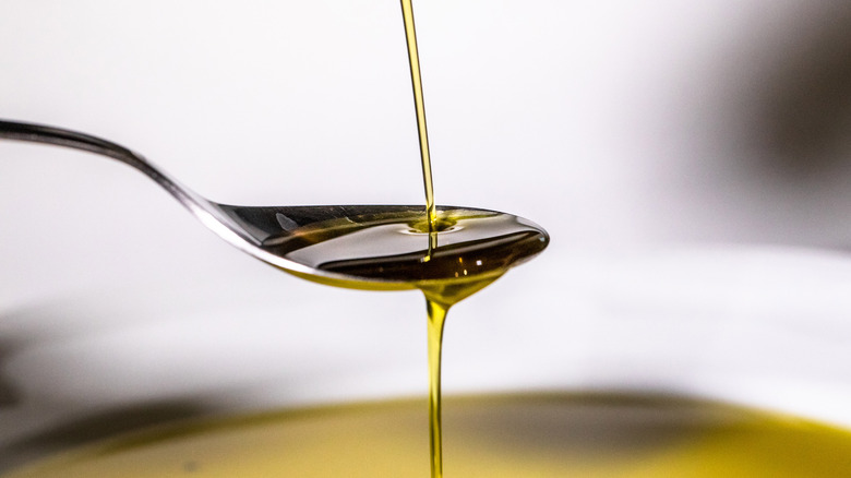 Pouring oil onto a spoon