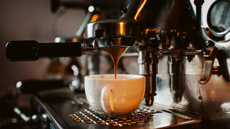 Espresso poured into coffee cup