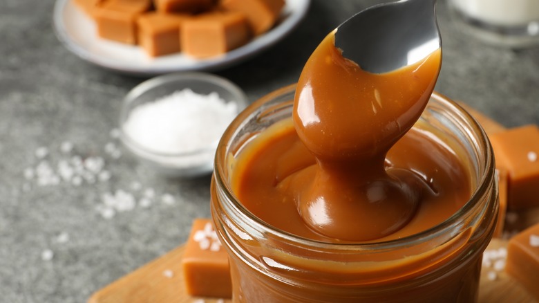 Salted caramel with spoon from glass jar 