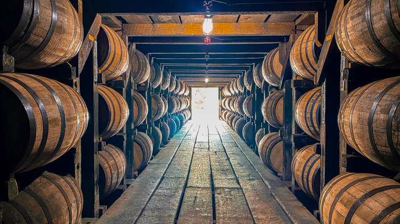 Bourbon barrels lined up in a rickhouse