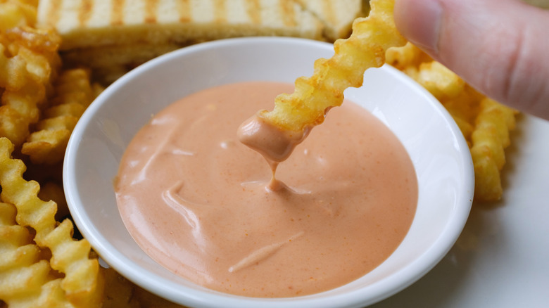 Dipping fry into sauce