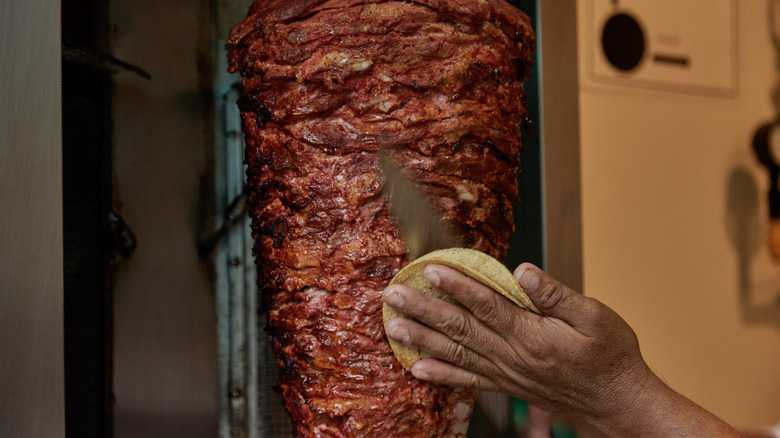 Cutting meat into a tortilla