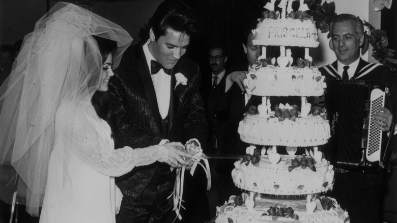 Elvis and Priscilla Presley cut wedding cake
