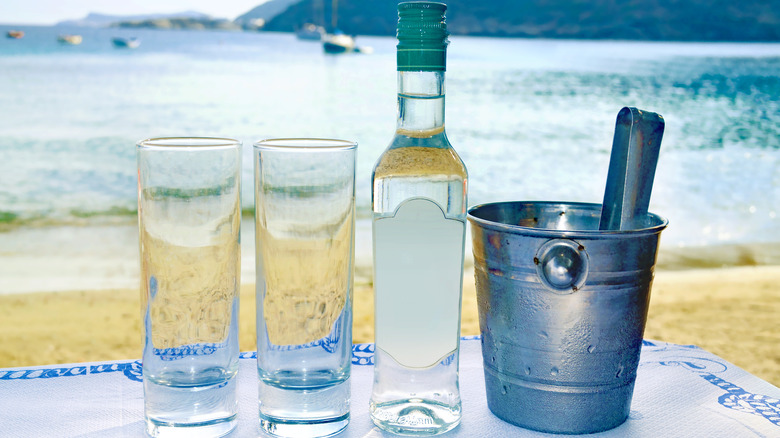 Ouzo and glasses on beach