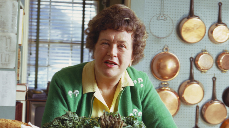 Julia Child in her kitchen with a green sweater