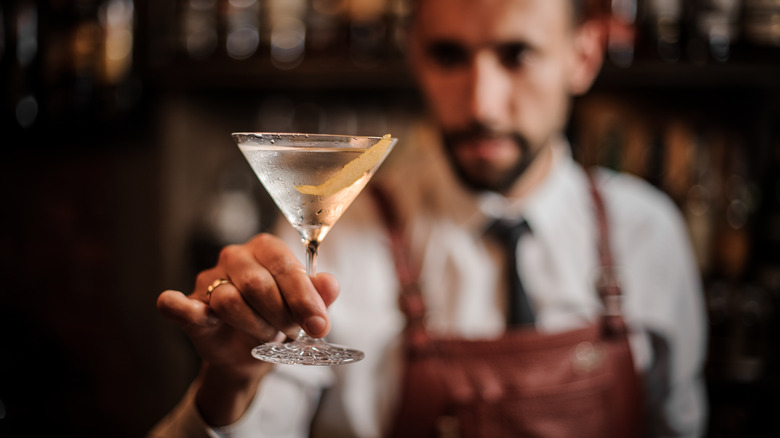 Bartender holds a martini