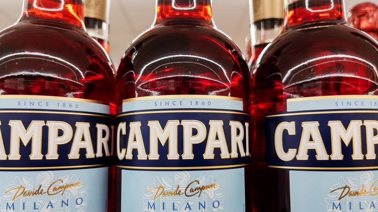 Bottles of Campari lined up on a shelf