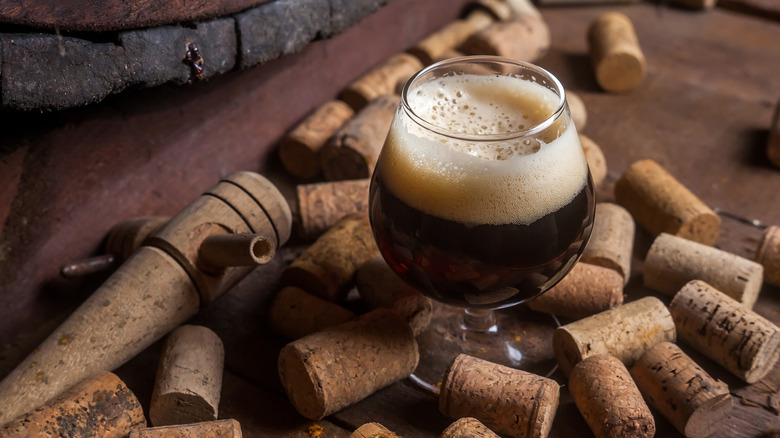 Old Ale in snifter surrounded by corks