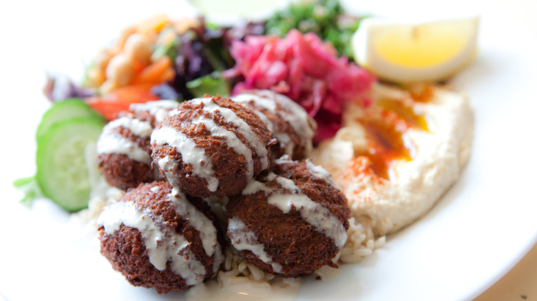 Falafel balls with tahini on mezze plate