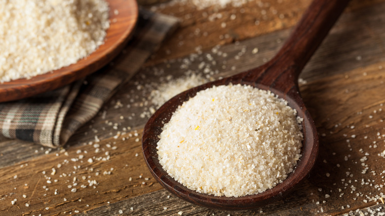 dry grits in a wooden spoon