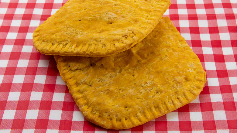 Jamaican patties on a red tablecloth.