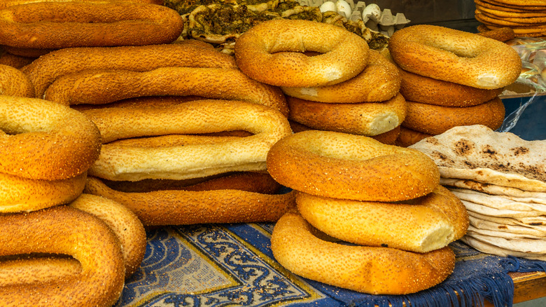 Piles of Jerusalem bagels next to pita