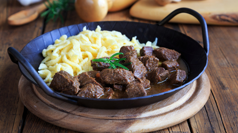 spätzle with beef in handled bowl