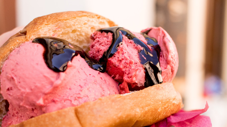 Pink gelato with chocolate drizzle in Sicilian brioche bread