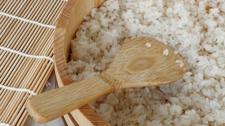 Bowl of sushi rice with wooden spoon