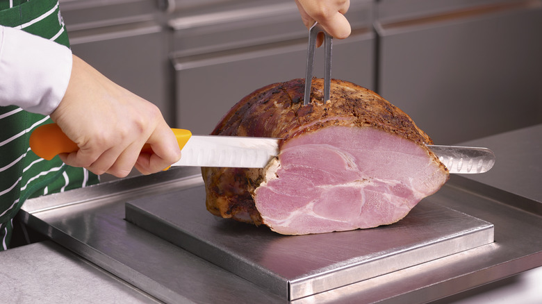 Cutting a ham on a counter