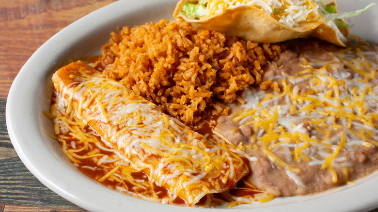 Tex-Mex combo plate with enchiladas, rice, beans, and a taco