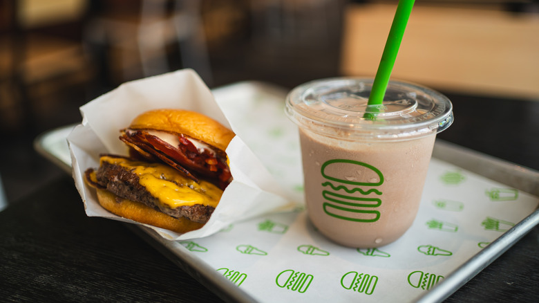 Shake Shack burger and shake on a tray.