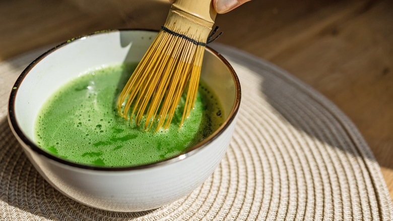 Matcha being prepared in a bowl