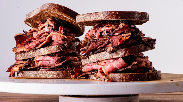 Meats piled on sandwiches