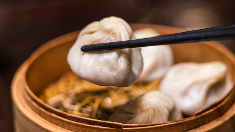 Soup dumpling being picked up with chopsticks