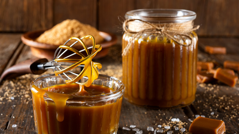 Caramel sauce in a glass jar and ramekin.