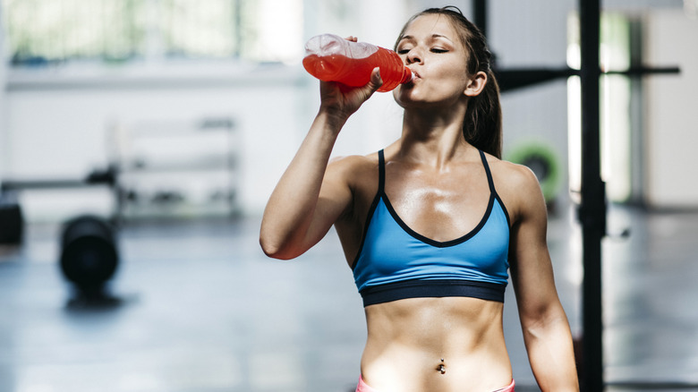 woman drinking sports drink after exercise
