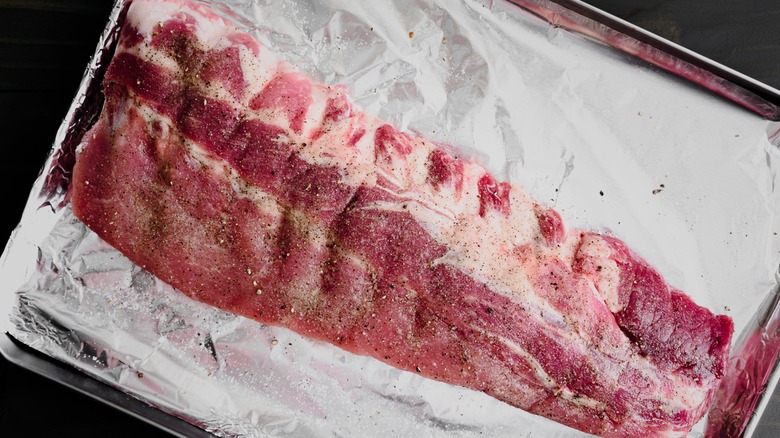 Raw seasoned baby back ribs