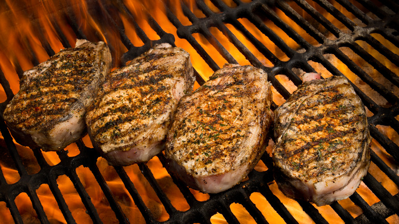 four pork chops being grilled