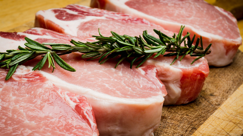 four raw pork chops