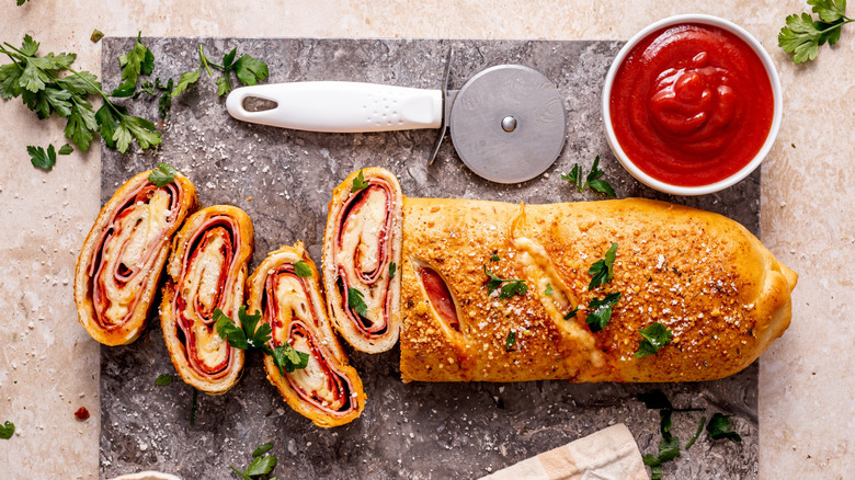 Partially sliced stromboli with sauce