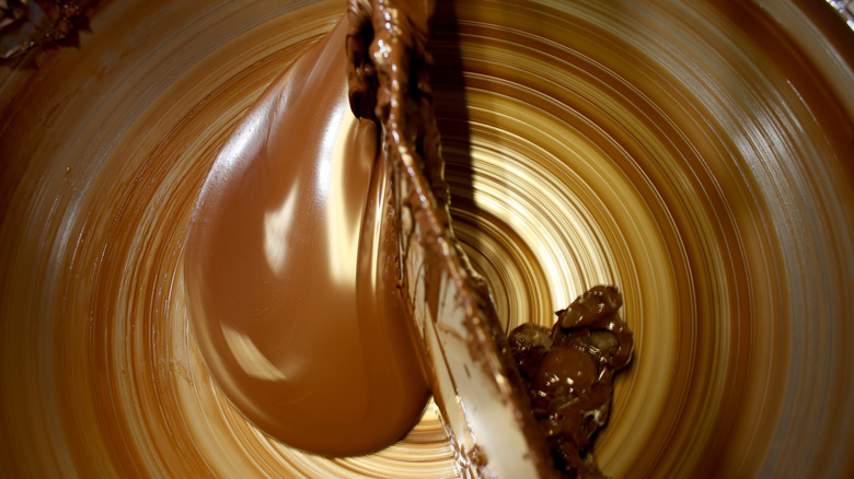 Melted chocolate being processed in a machine